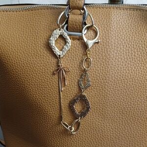 Gold tone handbag charm chain.